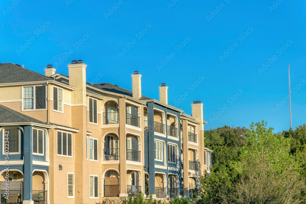 Austin, Texas- Apartment building near Lake Austin with blue and beige exterior