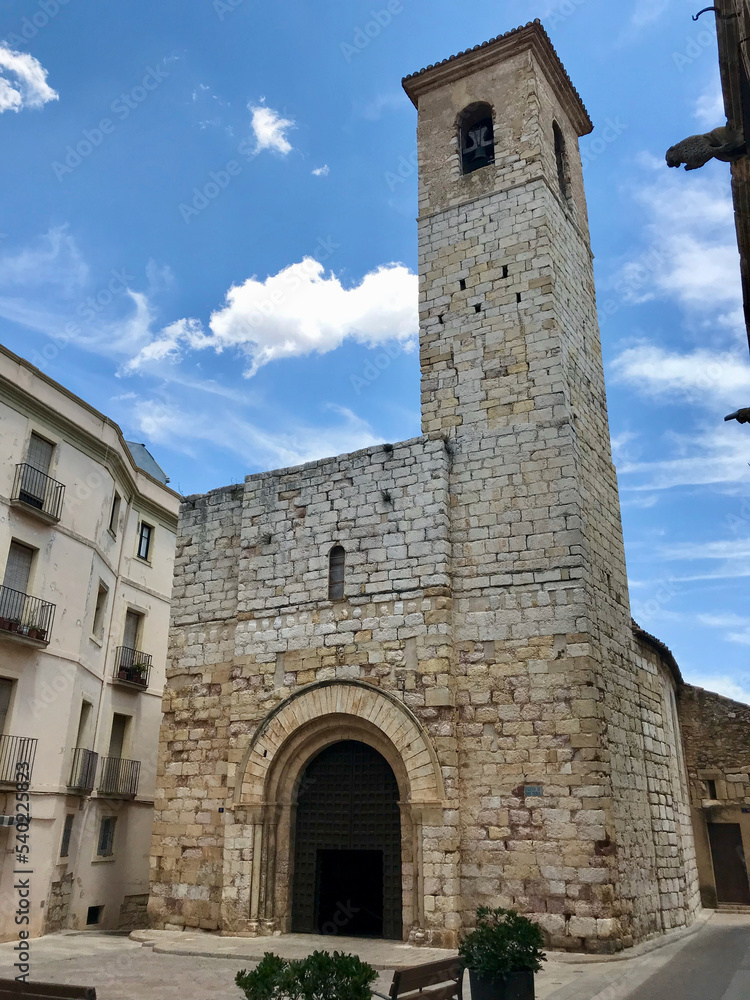 Montblanc, Spain, June 2019 - A large stone building with a clock tower