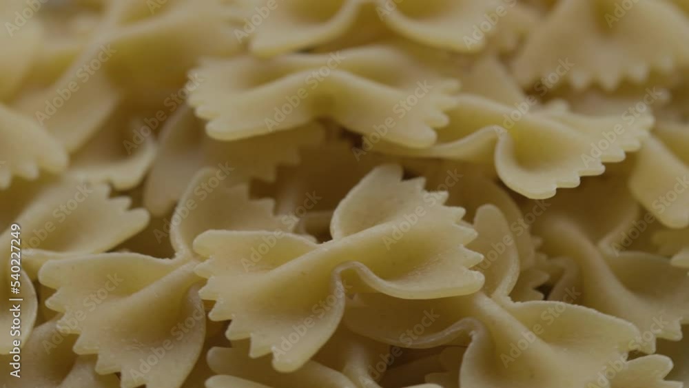 raw pasta in the form of bows rotate in a circle raw pasta in the form of bows rotate in a circle