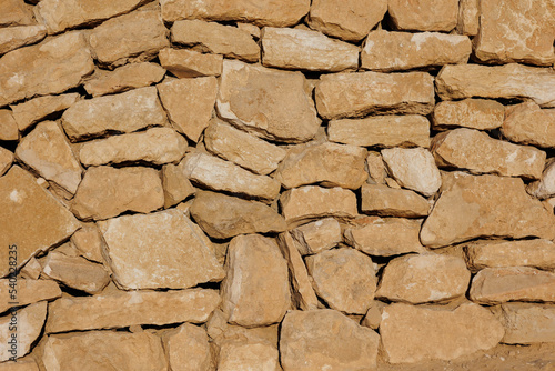 Texture of a stone wall of an ancient structure near Mitzpe Ramon, Israel photo