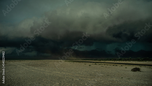 Cyclone storm clouds on the beach. Dramatic landscape. Dangerous natural phenomenon. Bad weather on the coast. Dust storm