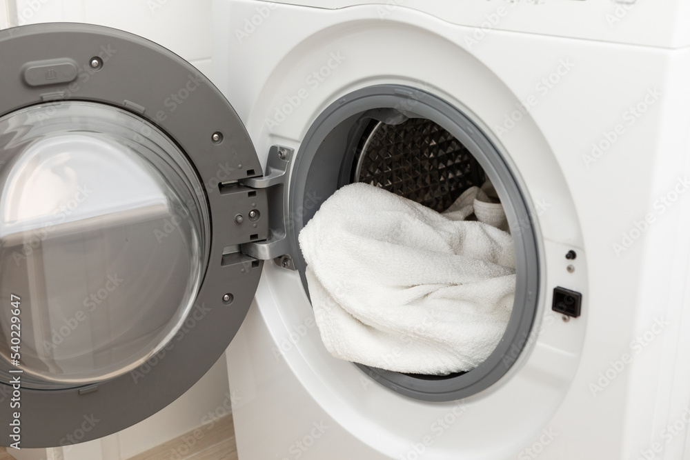 Modern washing machine with clean or dirty clothes in the middle Modern washing machine with clean or dirty clothes in the middle