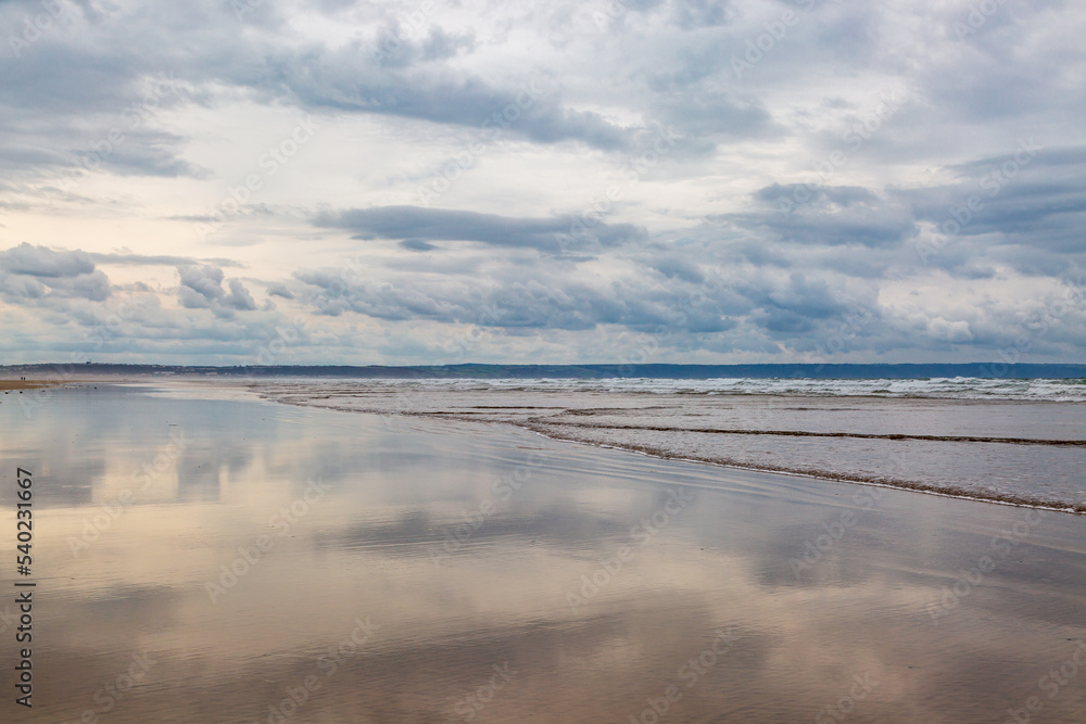 Looking along the sandy beach at low tide, at Saunton Sands in Devon