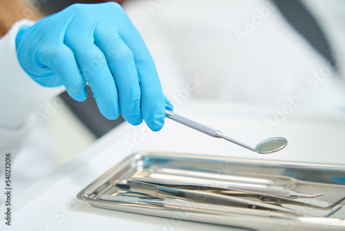 Dentist preparing for examining patient oral cavity
