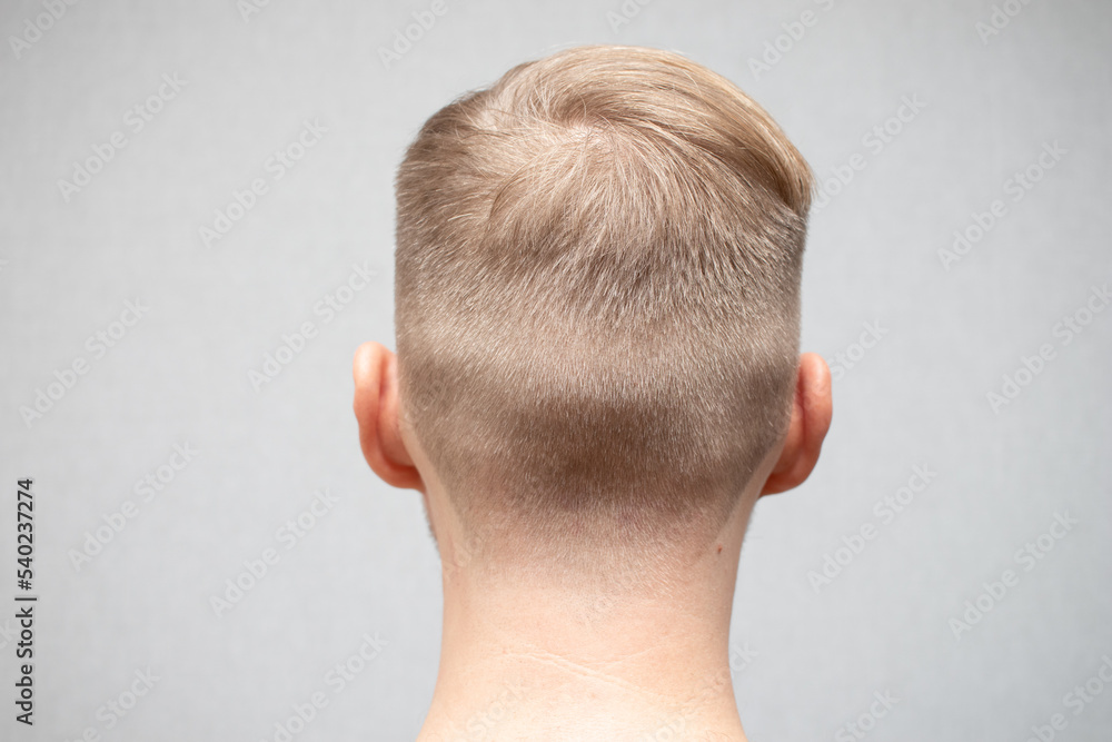 Fototapeta premium Close up portrait of handsome modern haircut man. Rear view of young man in barbershop.