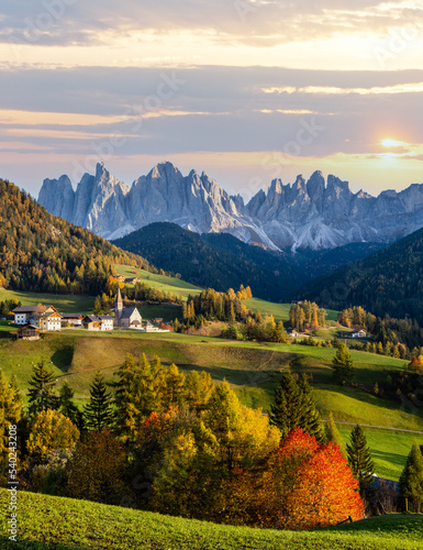 Autumn evening Santa Magdalena famous Italy Dolomites village view in front of the Geisler or Odle Dolomites mountain rocks. Picturesque traveling and countryside beauty concept background. © wildman