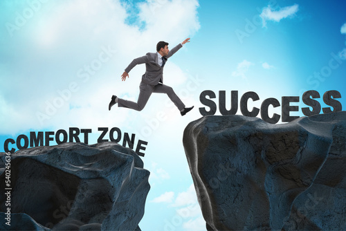 Bild auf Leinwand Businessman jumping over cliff in the concept