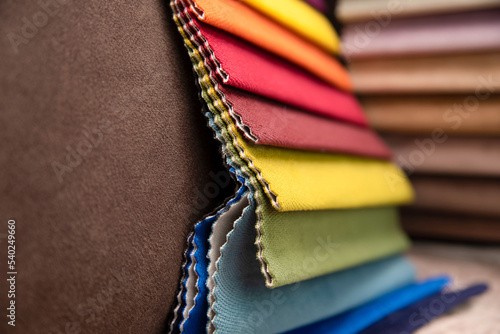 A close-up of a fabric catalog in a furniture store. Choosing fabric for upholstered furniture or fabric blinds
