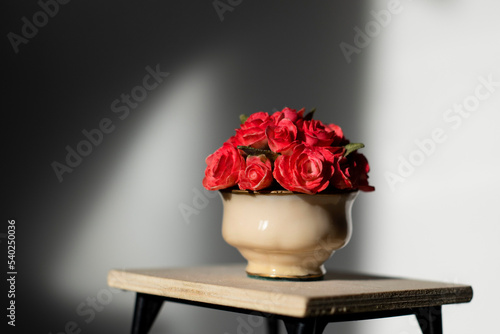 Wallpaper Mural Lonely vase of red flowers on a table Torontodigital.ca