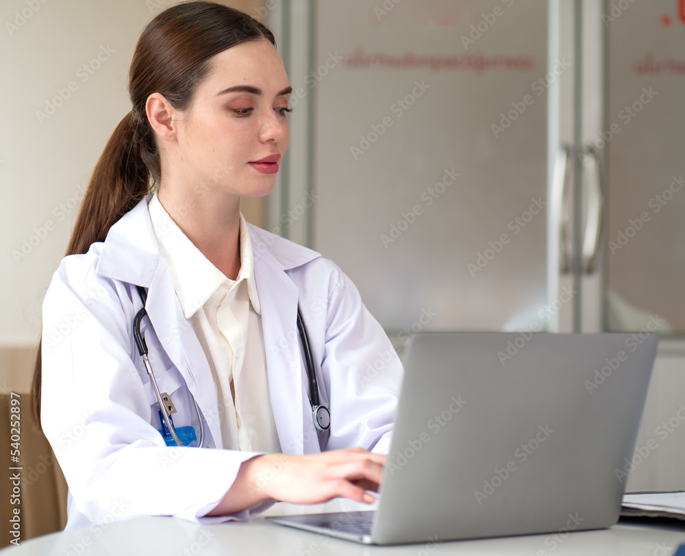 Female doctor meeting with medical teamwork woman using laptop computer in hospital. Beautiful professional healthcare expertise talking, explaining discussion with teamwork in medical clinic. Female doctor meeting with medical teamwork woman using laptop computer in hospital. Beautiful professional healthcare expertise talking, explaining discussion with teamwork in medical clinic.