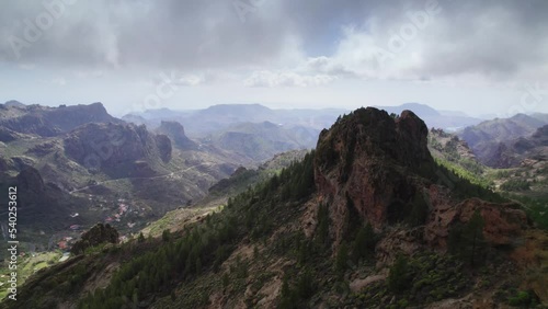 Flight over mountain landscape with cloudy sky in Gran Canaria island, Canary islands, Spain. 
 photo