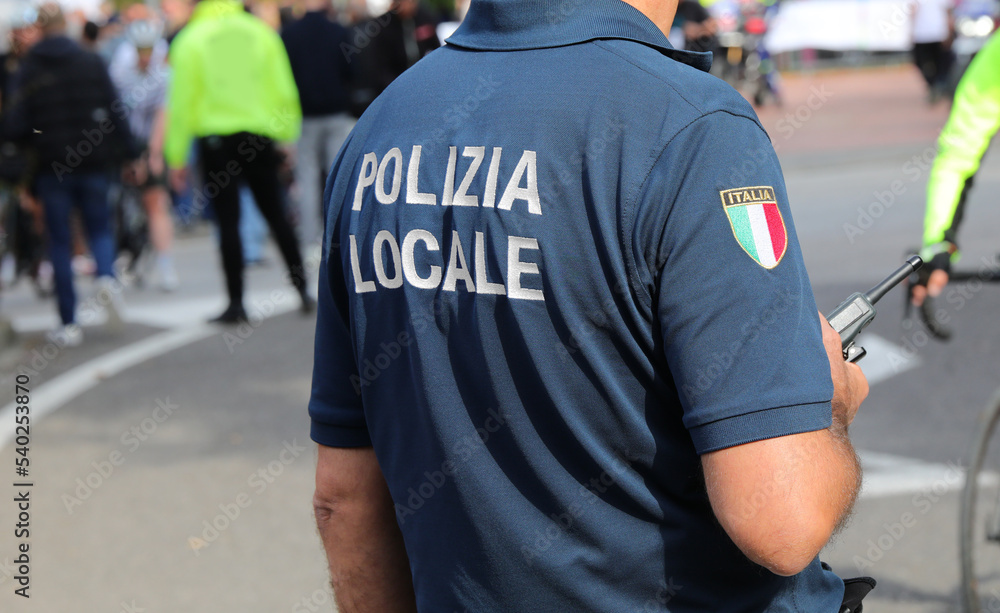 Vicenza, VI, Italy - October 9, 2022: policeman in uniform and text that means LOCAL POLICE in Italian Vicenza, VI, Italy - October 9, 2022: policeman in uniform and text that means LOCAL POLICE in Italian