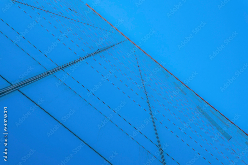Austin, Texas- Low angle view of a glass building with a reflection of blue sky Austin, Texas- Low angle view of a glass building with a reflection of blue sky