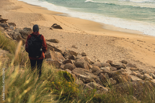 woman hiker walking on the beach