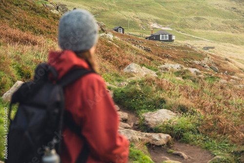 female hiker looking at the cabin hut