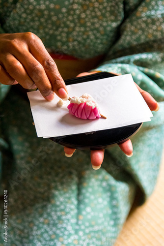 Принти на полотні Black woman cutting Wagashi with kuromoji wooden toothpick, Japanese Traditional