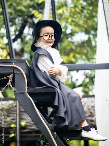 Asian children boy in Count Dracula dress costume for Halloween decoration in graden