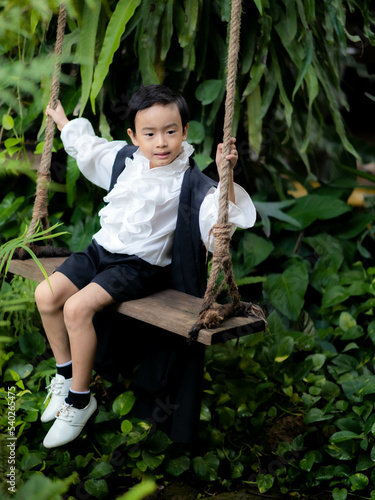 Asian children boy in Count Dracula dress costume for Halloween decoration in graden