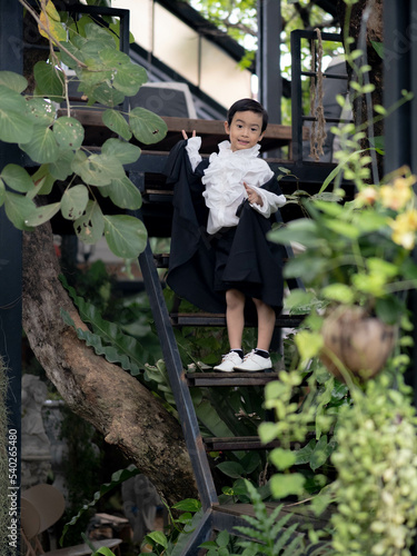 Asian children boy in Count Dracula dress costume for Halloween decoration in graden