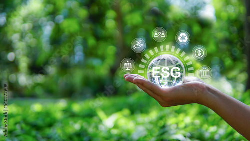 ESG icon concept in the hand for environmental,social and governance.words green background.sustainable environment concept