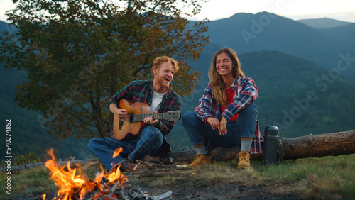 Two campers rest outdoors in mountains. Happy couple spend vacation closeup.