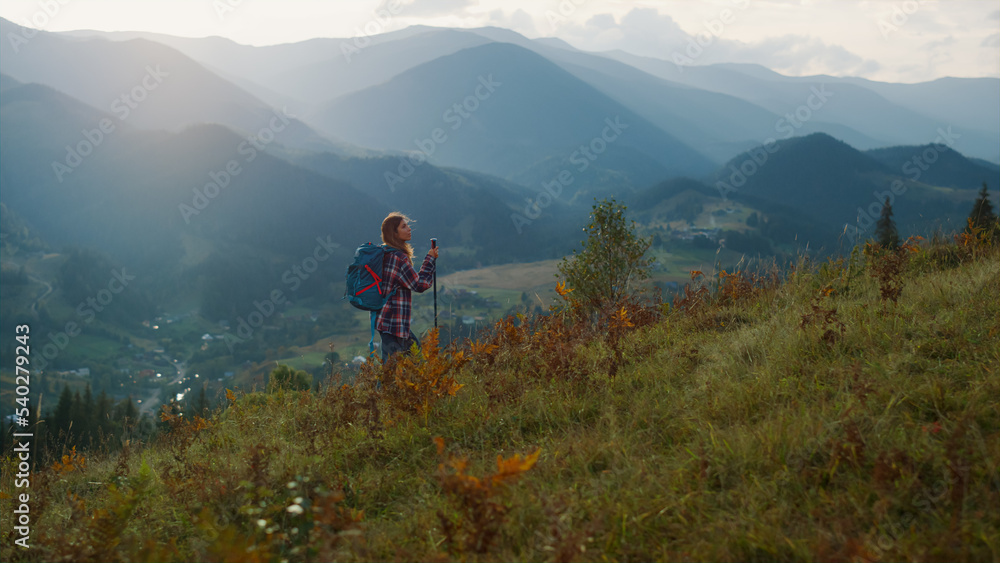 Active millennial travel mountains nature. Young woman trekking on landscape.
