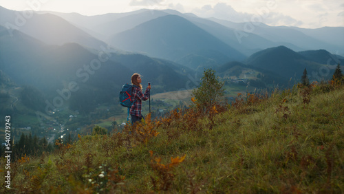 Active millennial travel mountains nature. Young woman trekking on landscape.