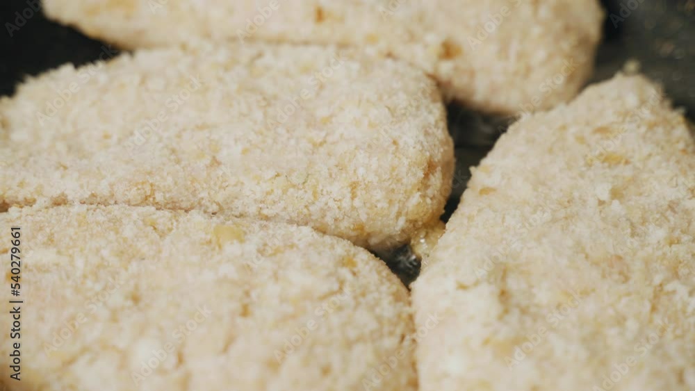 Cutlets in breadcrumbs are fried in a pan. Close-up. Food Cutlets in breadcrumbs are fried in a pan. Close-up. Food