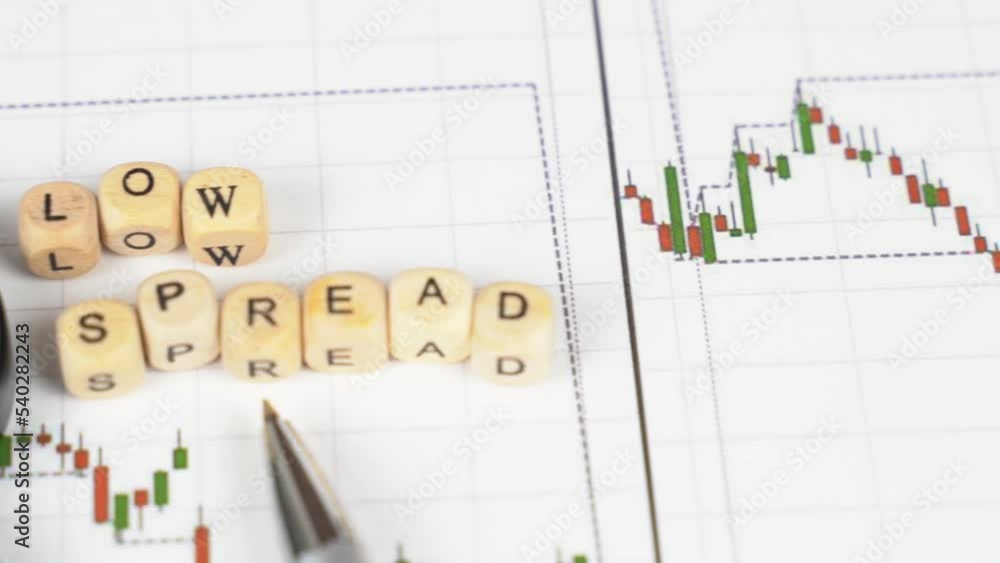 Business concept. Moving the camera from the quotation chart to the cubes with the inscription - Low spread Business concept. Moving the camera from the quotation chart to the cubes with the inscription - Low spread