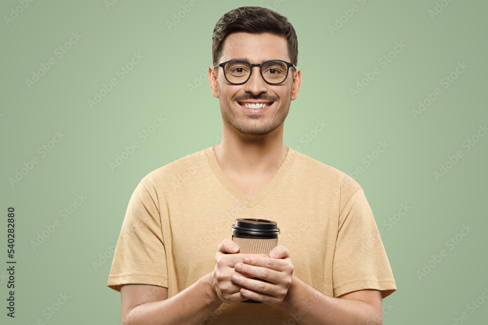 Man in t-shirt and eyeglasses standing with coffee cup in hands, ready to enjoy his break from work Man in t-shirt and eyeglasses standing with coffee cup in hands, ready to enjoy his break from work