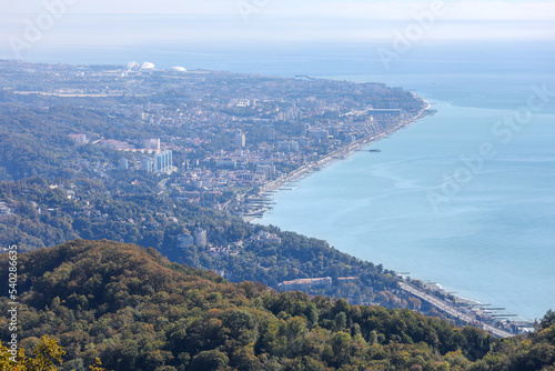 Aerial view of the city on the seashore. A beautiful modern city from a height. Sochi, Russia. Olympic Park.