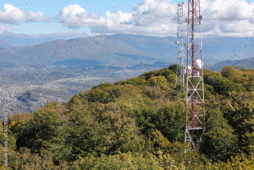 Autumn view of metal structures on the top of high mountain above clouds. Wireless telephone connection and Internet.