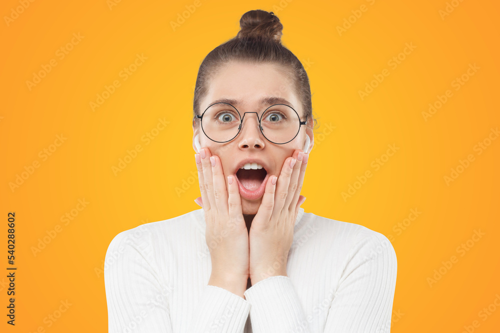 Amazed girl pressing palms to cheeks with deep amazement, feeling shocked by great commercial offer Amazed girl pressing palms to cheeks with deep amazement, feeling shocked by great commercial offer
