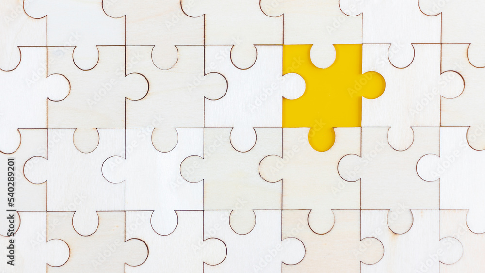White Wood jigsaw puzzle on yellow background with copy space. Business strategy teamwork or problem solving concept. White Wood jigsaw puzzle on yellow background with copy space. Business strategy teamwork or problem solving concept.