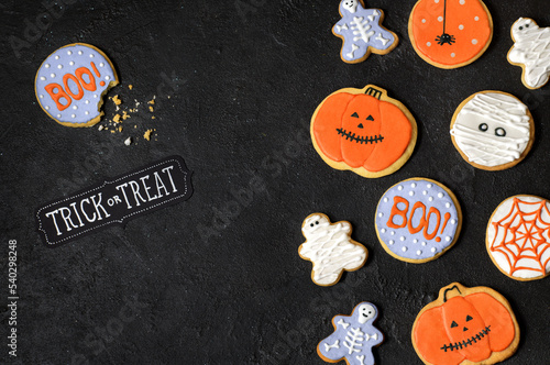 Homemade cookies for Halloween party on a black background.