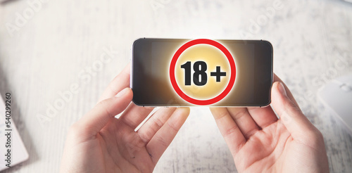 Картината върху платно Human using mobile phone with a 18+ symbol.