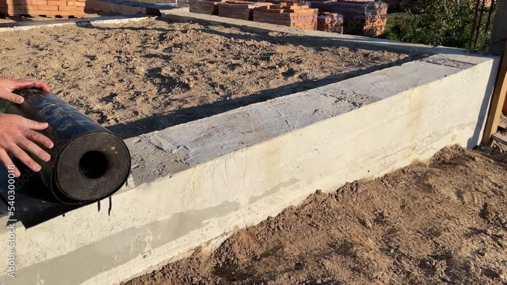 Construction work on waterproofing the foundation. Roll waterproofing Construction work on waterproofing the foundation. Roll waterproofing