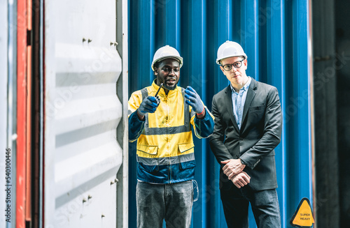 Container worker discussing their daily task together before they start their daily task.