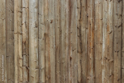 Background, texture of a wooden fence from old weathered gray boards