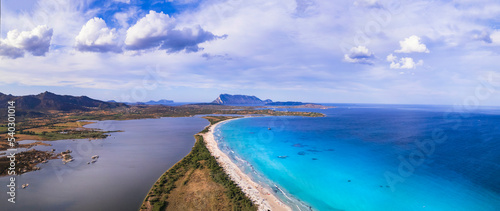 Italy. Sardegnia island nature scenery and best beaches. Aerial drone panoramic view of stunning La Cinta beach with turquoise sea and sault lake