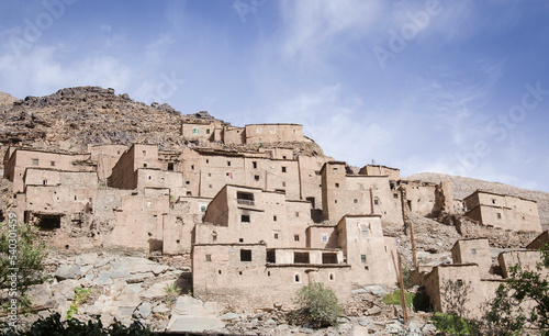 ancient village  castle on hills  in the Moroccan mountains  beautiful nature  large valleys  historical ruins  sublime architecture built by natural means  stone and sand.