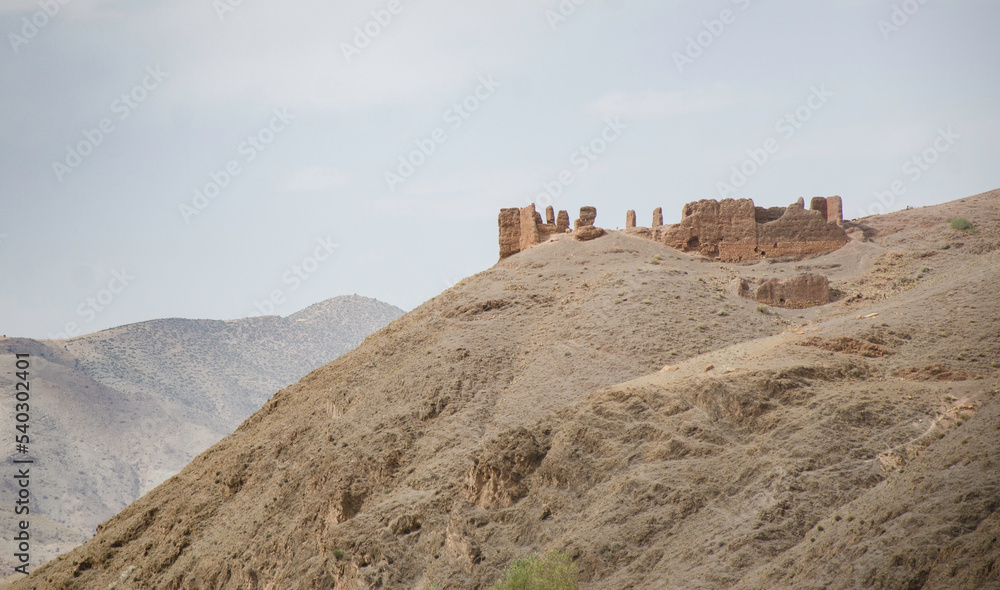 ancient village, castle on hills, in the Moroccan mountains, beautiful nature, large valleys, historical ruins, sublime architecture built by natural means, stone and sand.