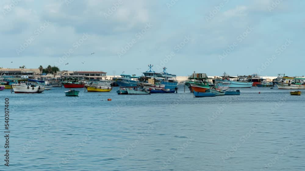 Yachts, boats floating on sea in port of Alexandria. Timelapse. Egyptian seaport with colorful ships, rowboats rocking on waves in dock. Marine landscape, seascape, sealine, waterfront Yachts, boats floating on sea in port of Alexandria. Timelapse. Egyptian seaport with colorful ships, rowboats rocking on waves in dock. Marine landscape, seascape, sealine, waterfront