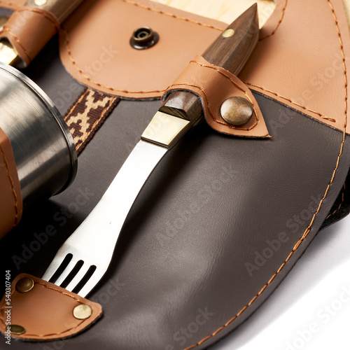 stainless steel fork on leather bag © ALFONSO