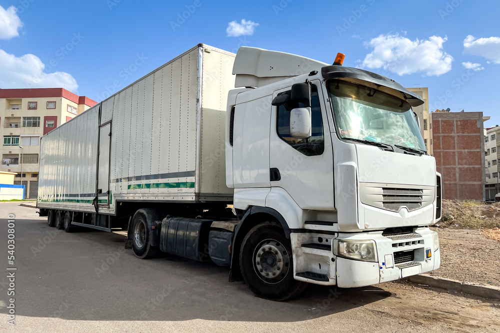 Long white trailer truck parked on the road Long white trailer truck parked on the road