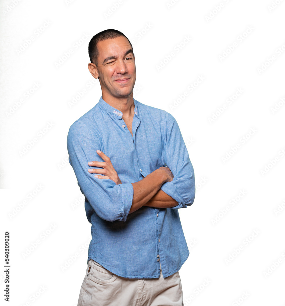 Friendly young man winking an eye Friendly young man winking an eye