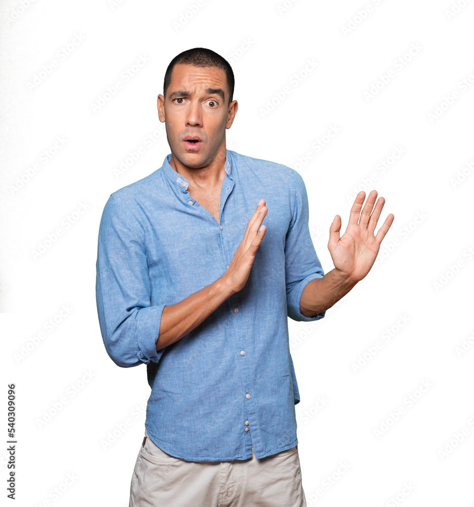 Scared young man screaming against background Scared young man screaming against background