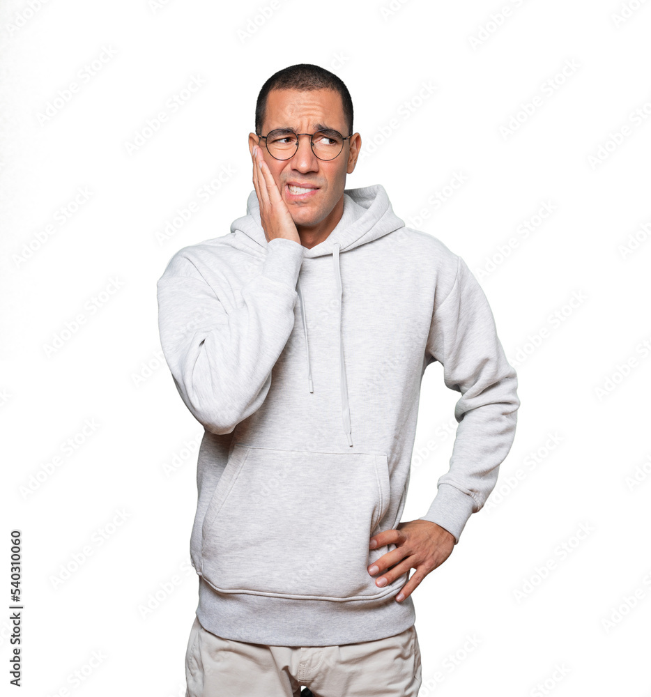 Concerned young man doing a gesture of relief Concerned young man doing a gesture of relief