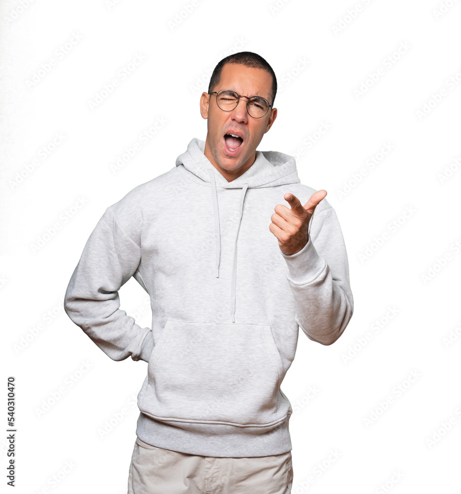 Amazed young man pointing at you with his finger Amazed young man pointing at you with his finger