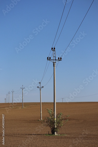 electric transmission poles pass through the field. Power line